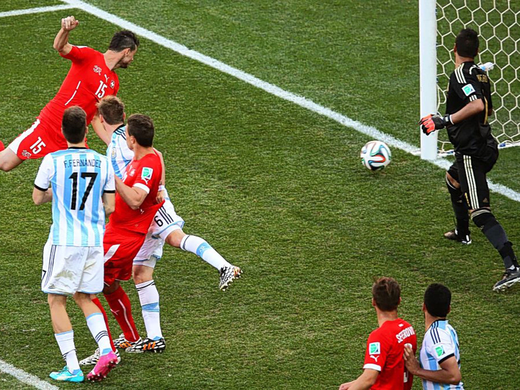 Switzerland’s Blerim Dzemaili heads against the Argentina post in the last few seconds of their match