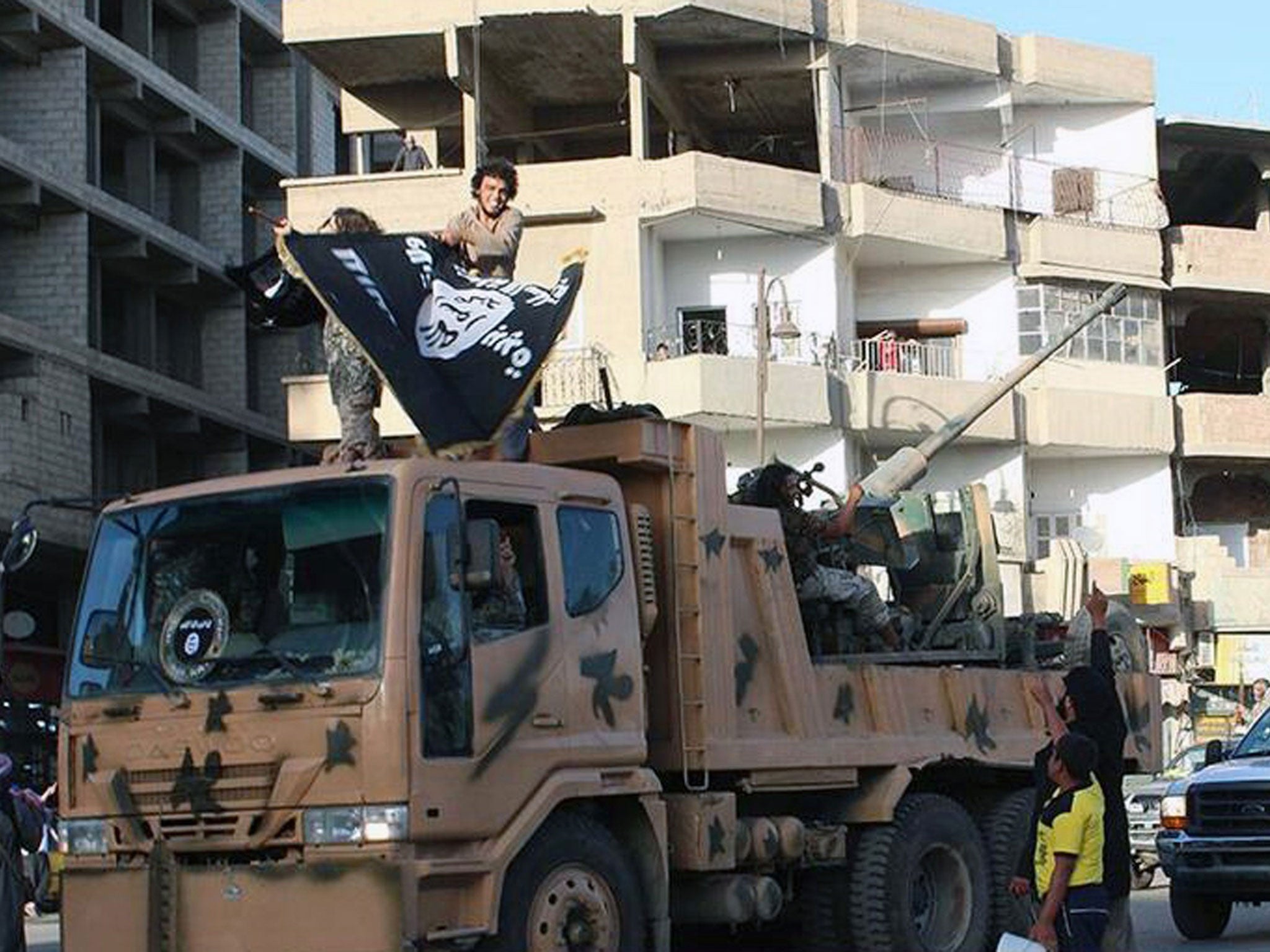 Fighters from the Isis group during a parade in Raqqa, Syria