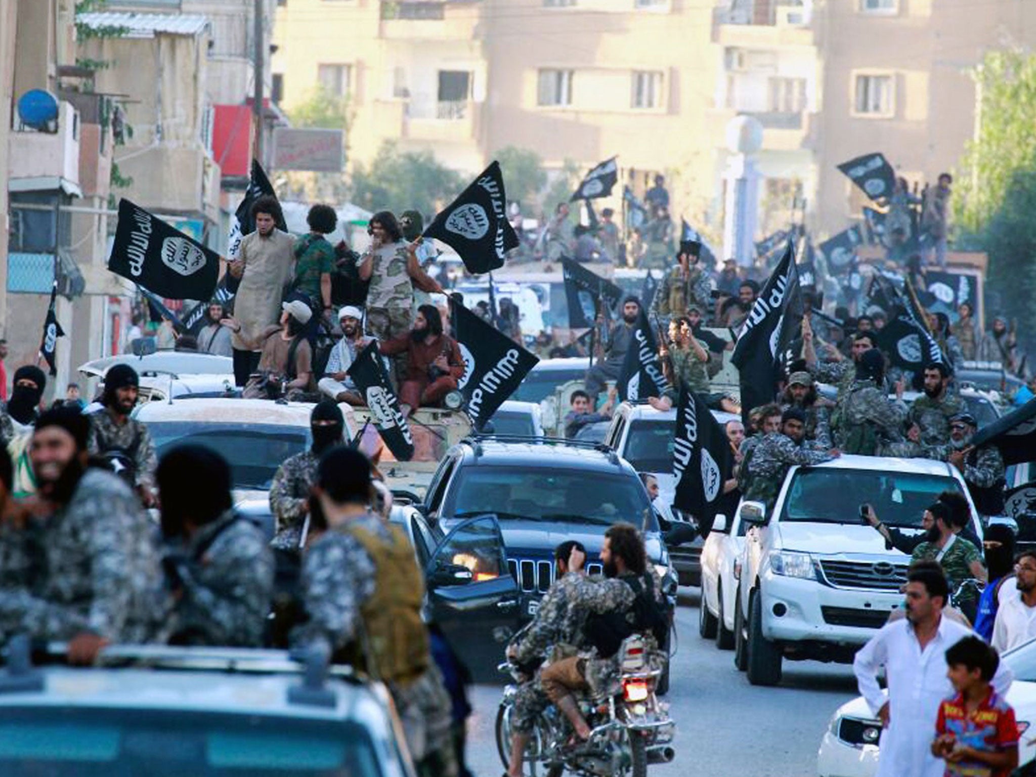 Isis fighters during a parade in Raqqa, Syria