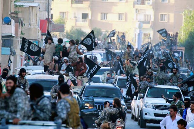 Isis fighters during a parade in Raqqa, Syria 