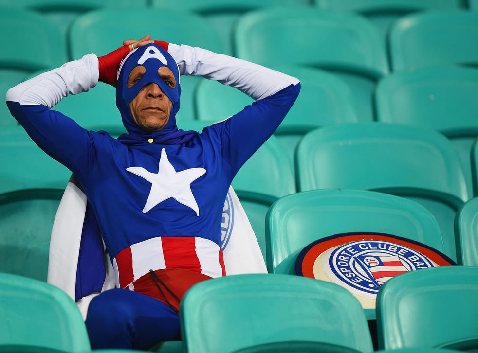 A fan dressed as Captain America looks on after Belgium's 2-1 victory in extra time during the 2014 FIFA World Cup Brazil