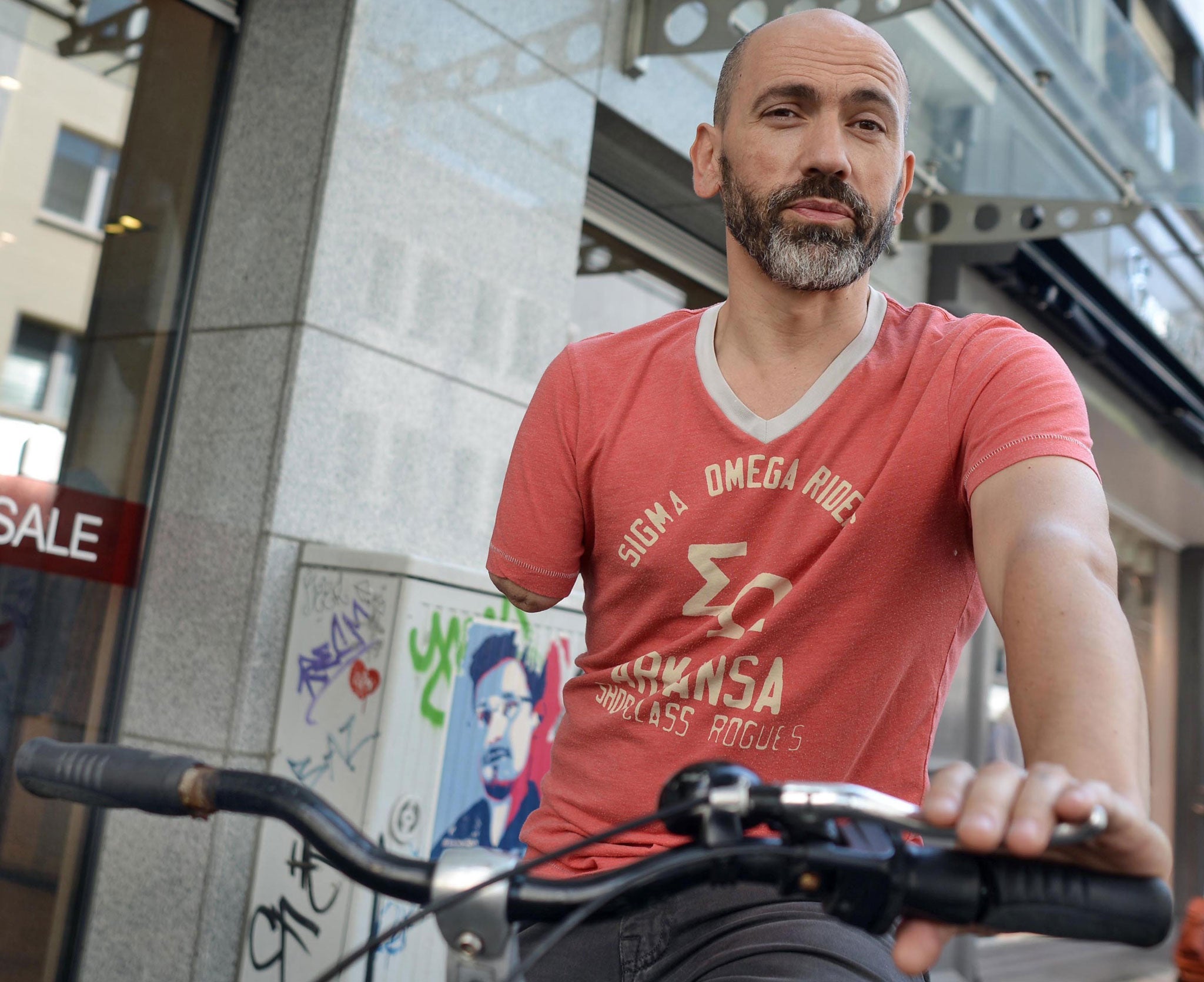 One-armed cyclist Bogdan Ionescu poses with his bike on July 1, 2014 in Cologne, western Germany