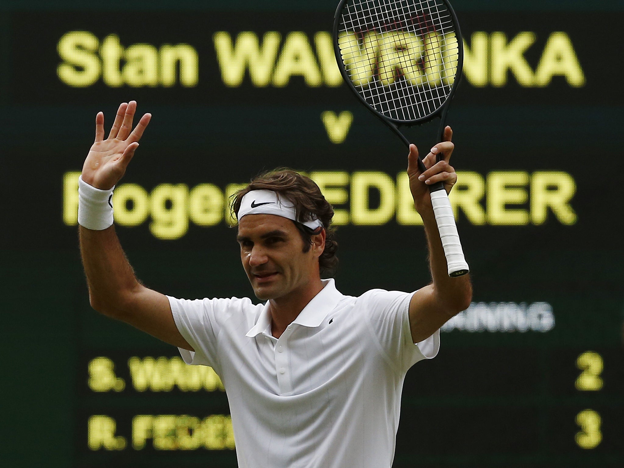 Roger Federer celebrates winning his men's singles quarter-final match against Stanislas Wawrinka