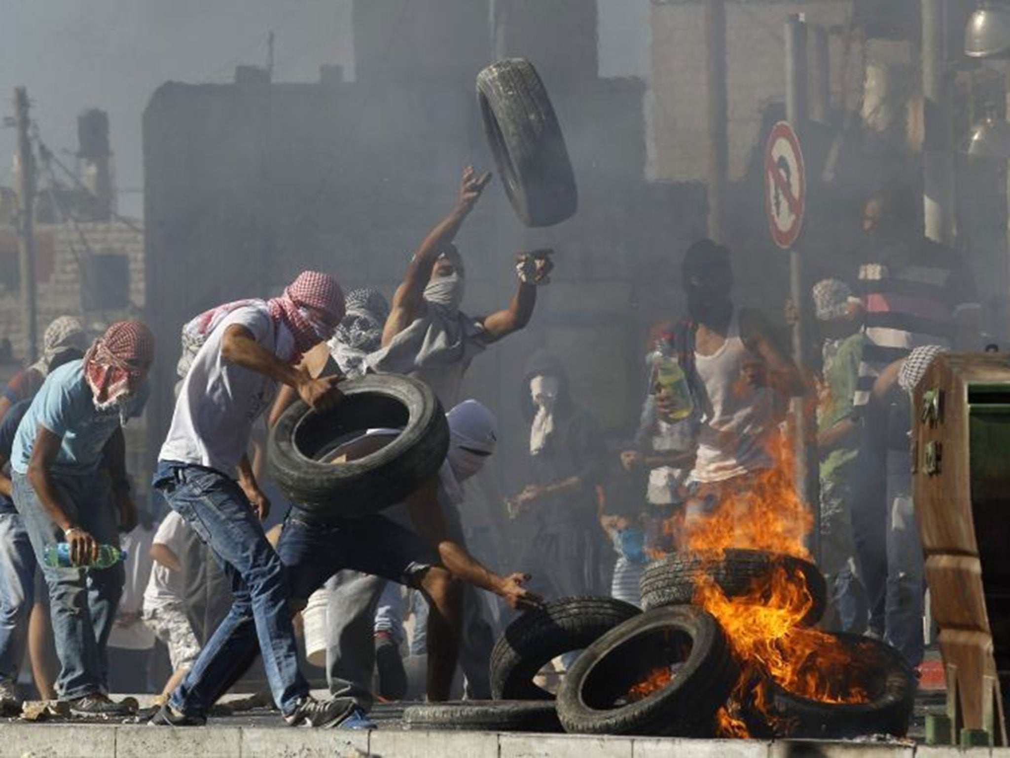 Palestinians set tyres ablaze during clashes with Israeli police in Shuafat, an Arab suburb of Jerusalem