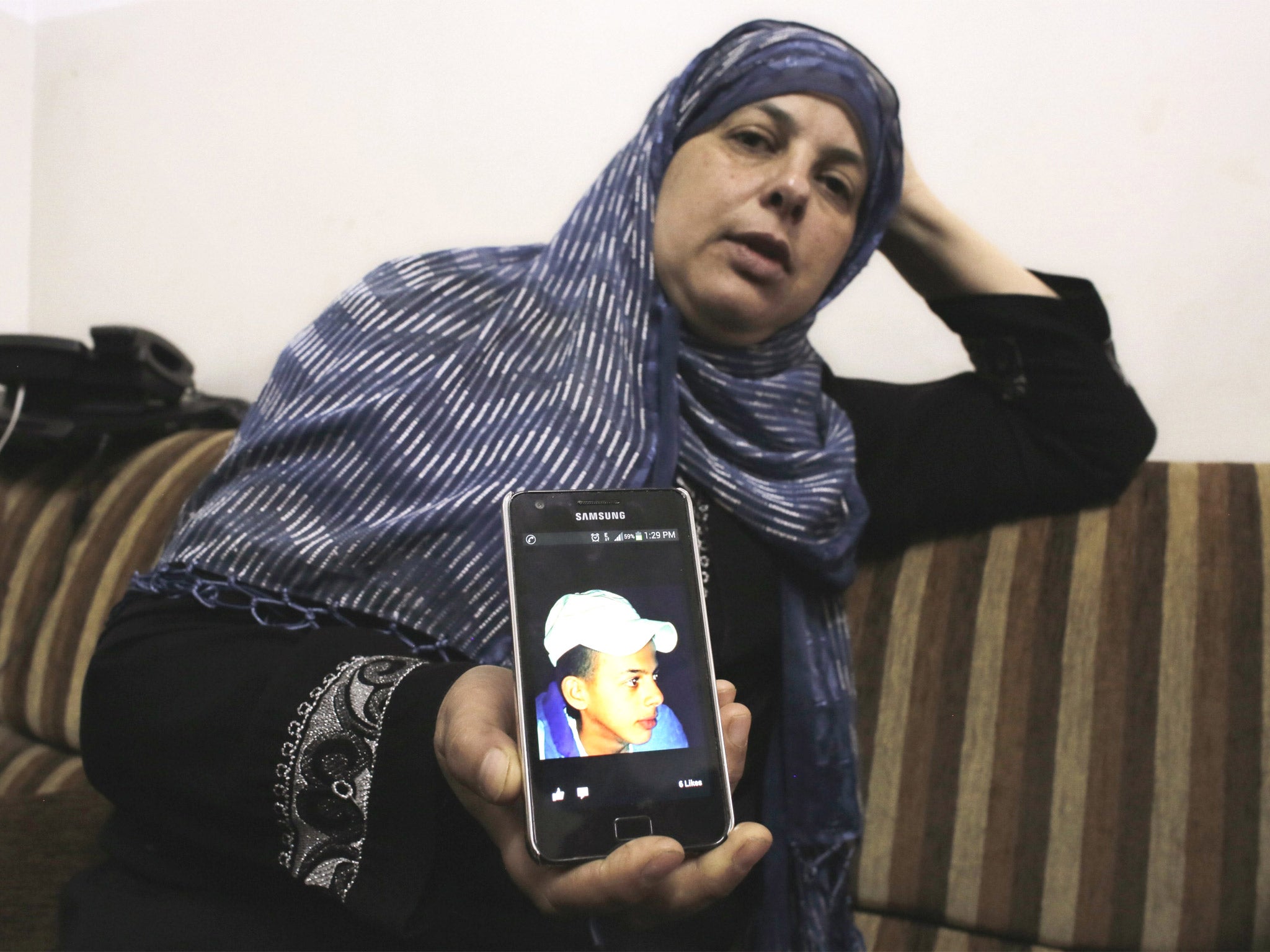 The mother of Mohammed Abu Khdeir shows a picture of her son