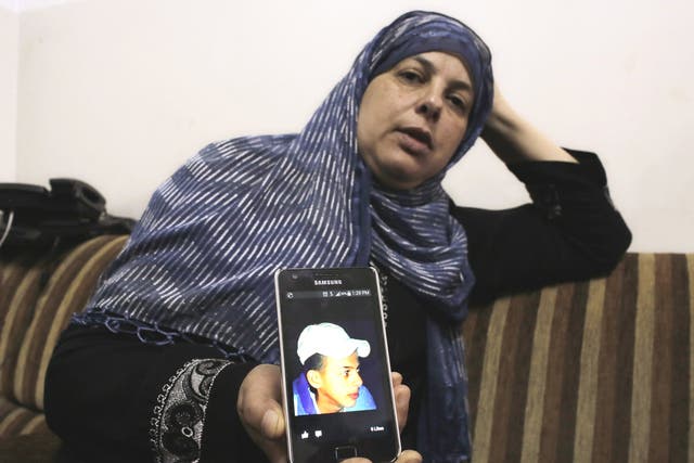 The mother of Mohammed Abu Khdeir shows a picture of her son