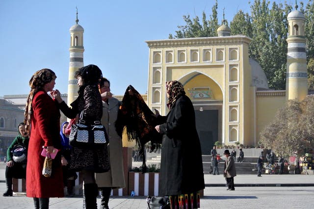 A group of Uighur women outside a mosque in Kashgar, farwest China’s Xinjiang region, November 2013