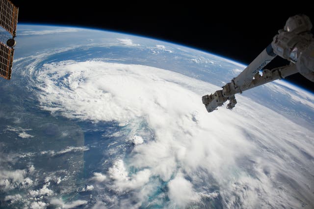 In this handout provided by NASA from the the Earth-orbiting International Space Station, weather system Arthur travels up the east coast of the United States in the Atlantic Ocean near Florida in space. The robotic arm of the Space Station Remote Manipul