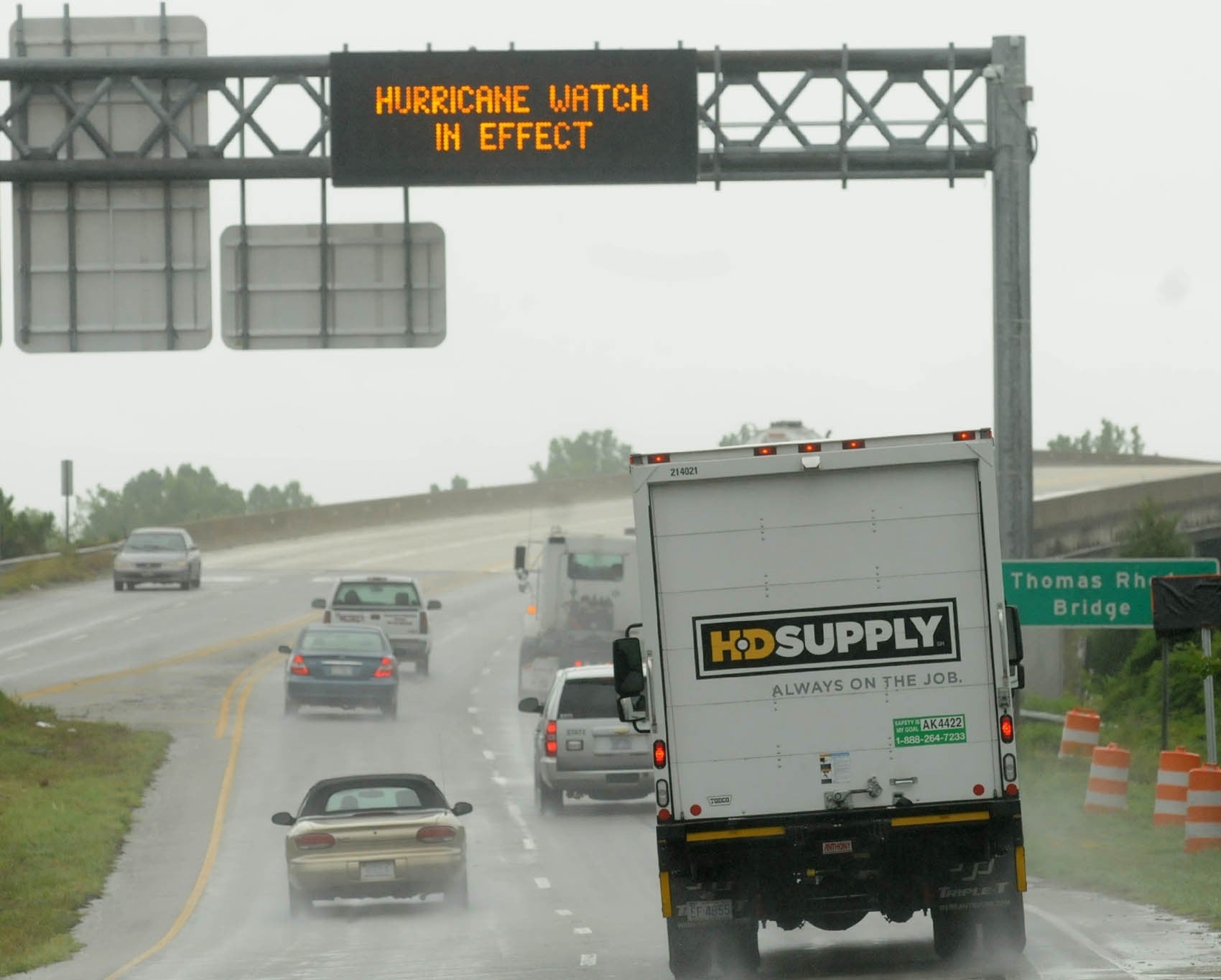 Vehicles travel across the Thomas Rhodes Bridge as rain falls in Wilmington, N.C. Residents along the coast of North Carolina are bracing for the arrival of the Hurricane Arthur, a category one storm