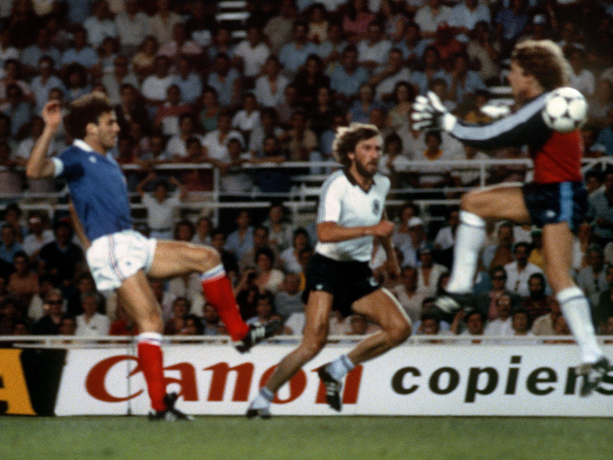 Harald Schumacher (right) charges out to collide with Patrick Battiston (left) in 1982