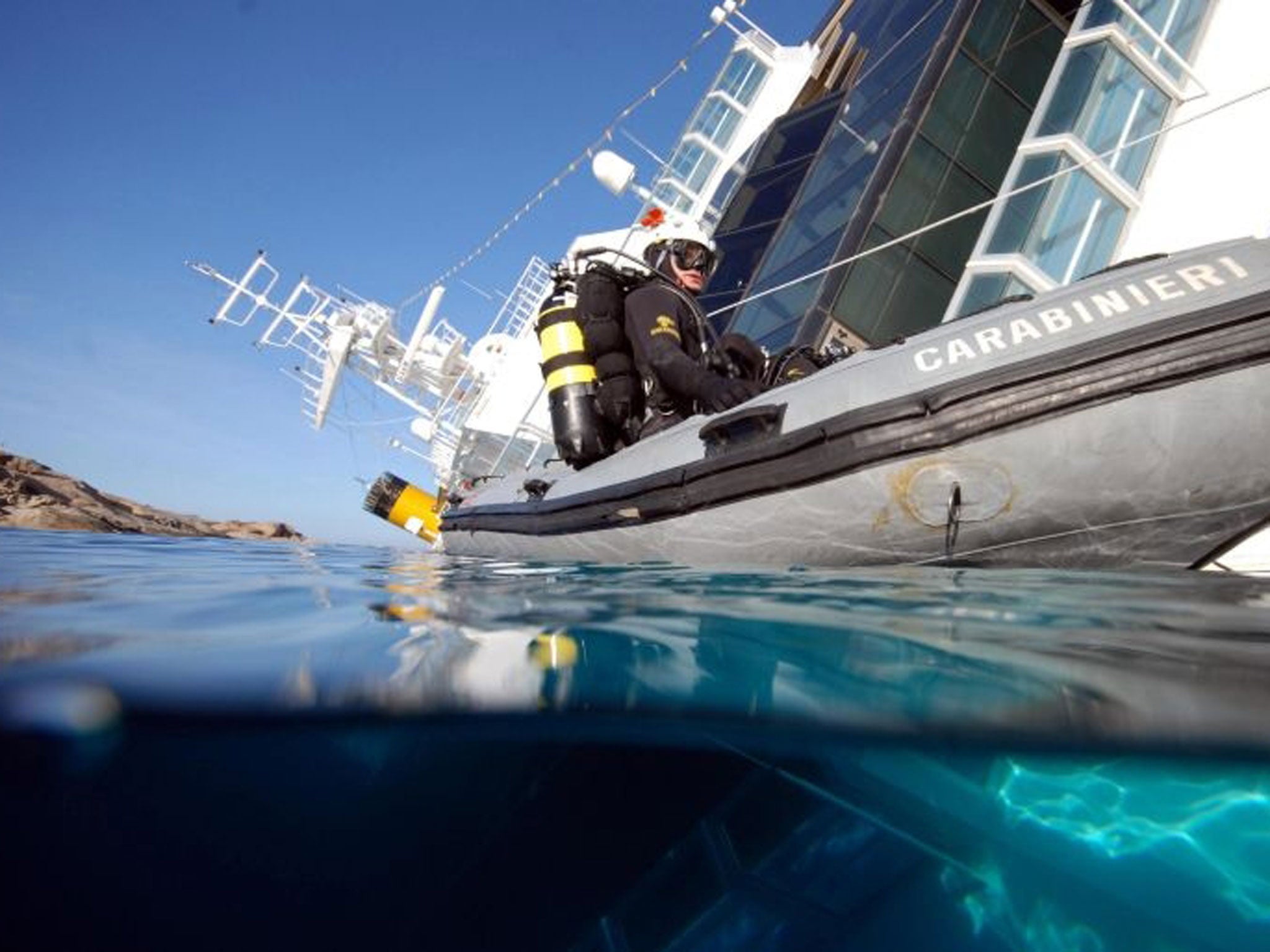 epa04297024 A picture released by the Italian Carabinieri on 03 July 2014 shows Carabinieri divers inspecting the Costa Concordia cruise ship, at Giglio Island, Italy, in 2012. The Costa Concordia hit a reef and partly capsized on 13 January 2012, after b