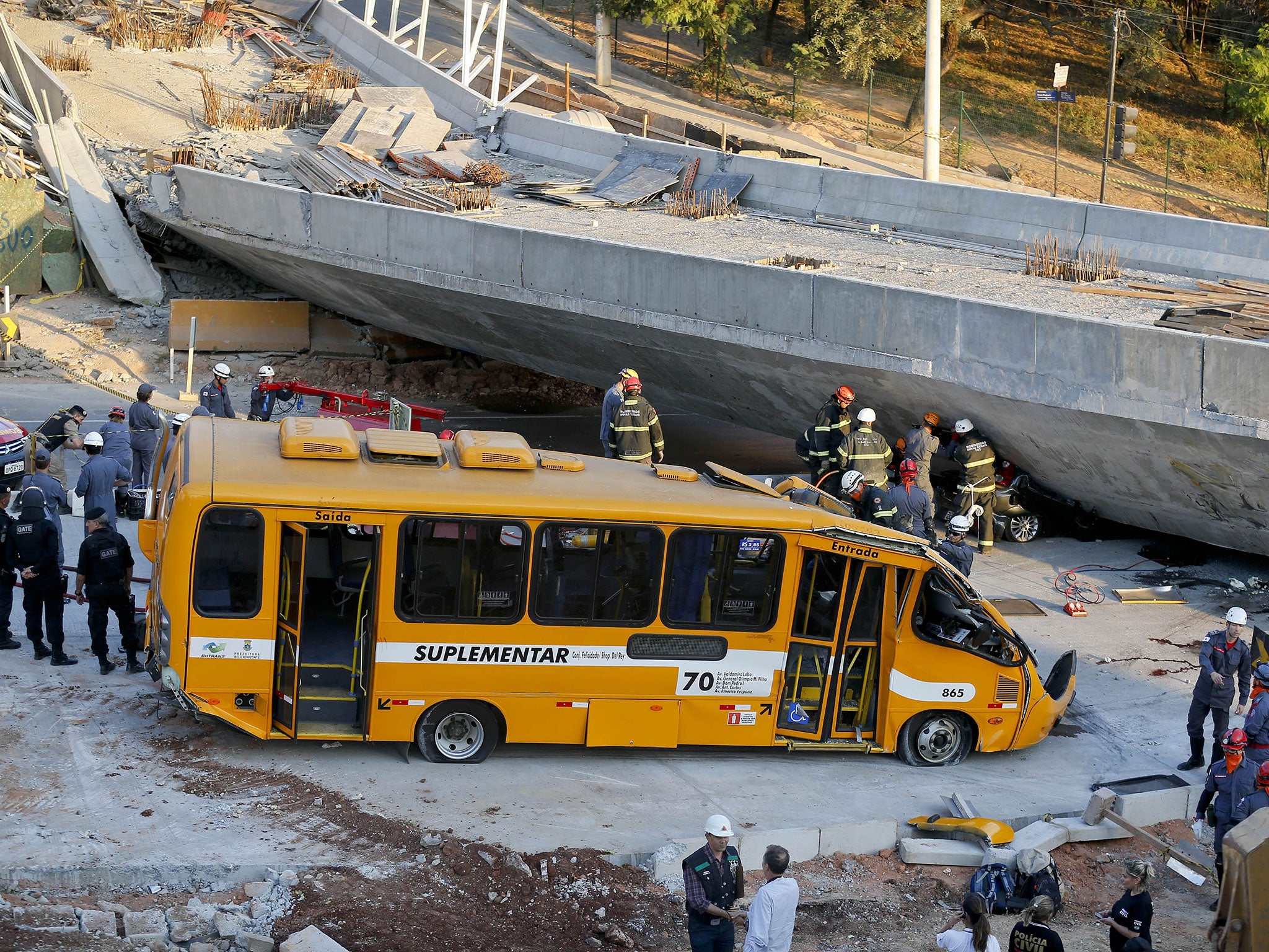 A bus sits damaged after a bridge collapsed in Belo Horizonte, Brazil