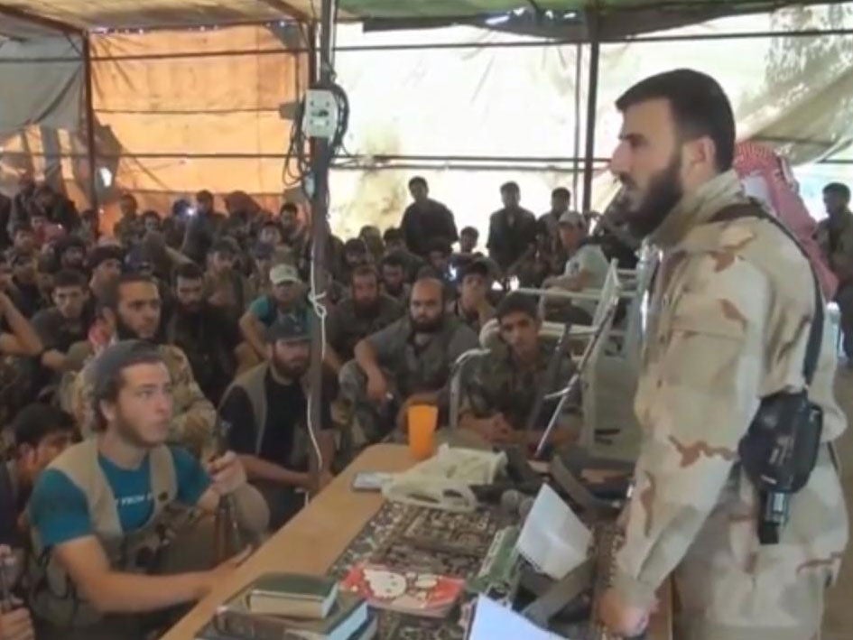 Zahran Alloush, the military leader of the Islamic Front, talking to militants near Damascus