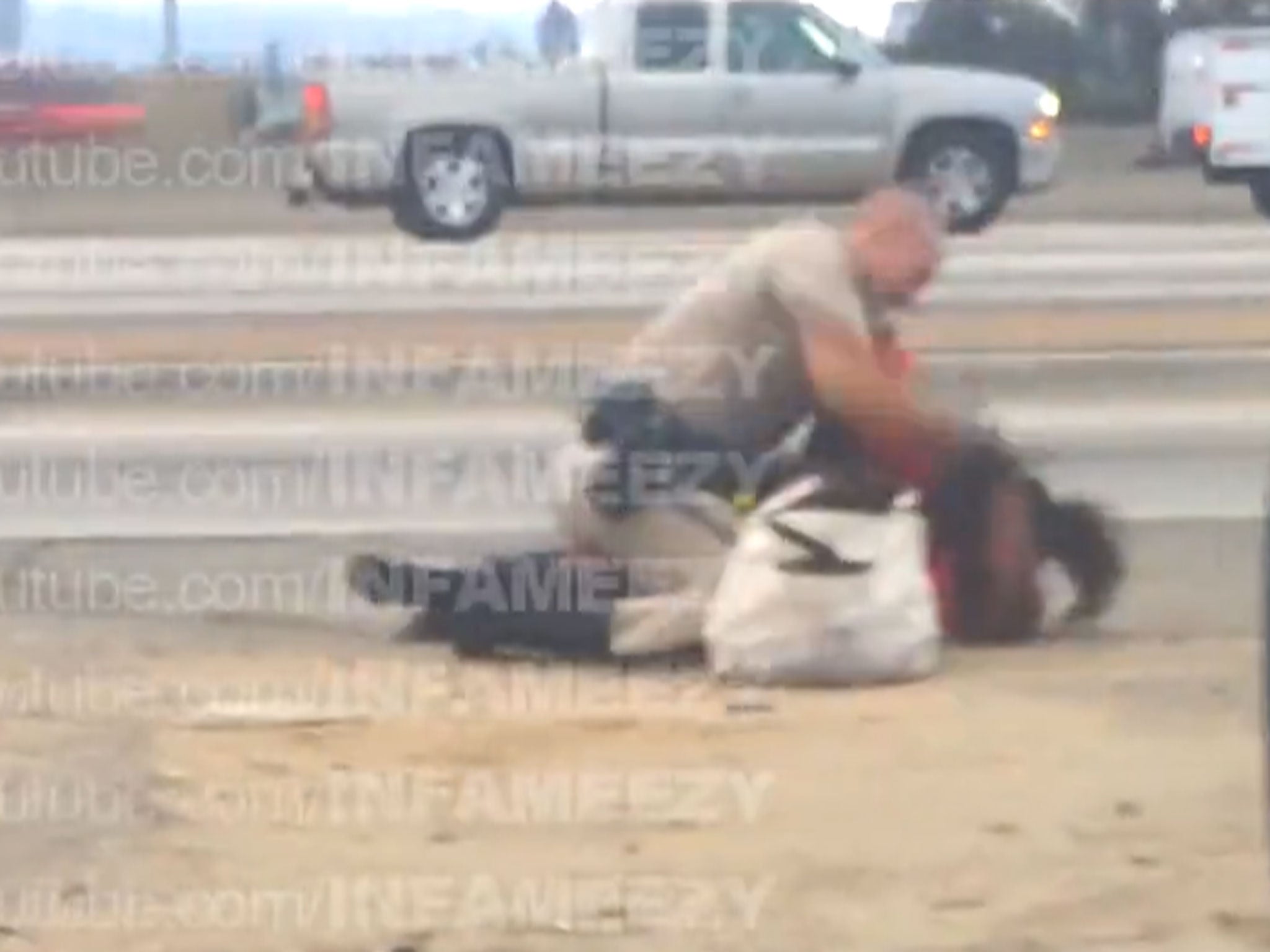 A still from a video appearing to show a CHP officer repeatedly punching a woman in the head