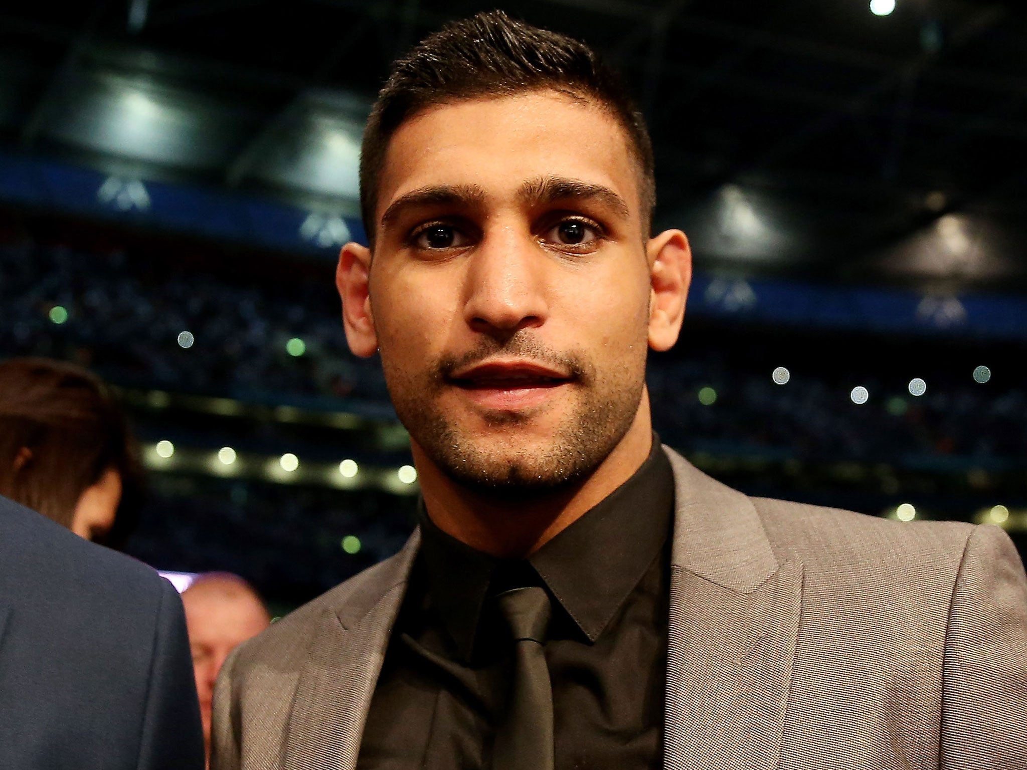 Amir Khan looks on during the IBF and WBA World Super Middleweight Championship bout between Carl Froch and George Groves at Wembley Stadium on May 31, 2014 in London, England.
