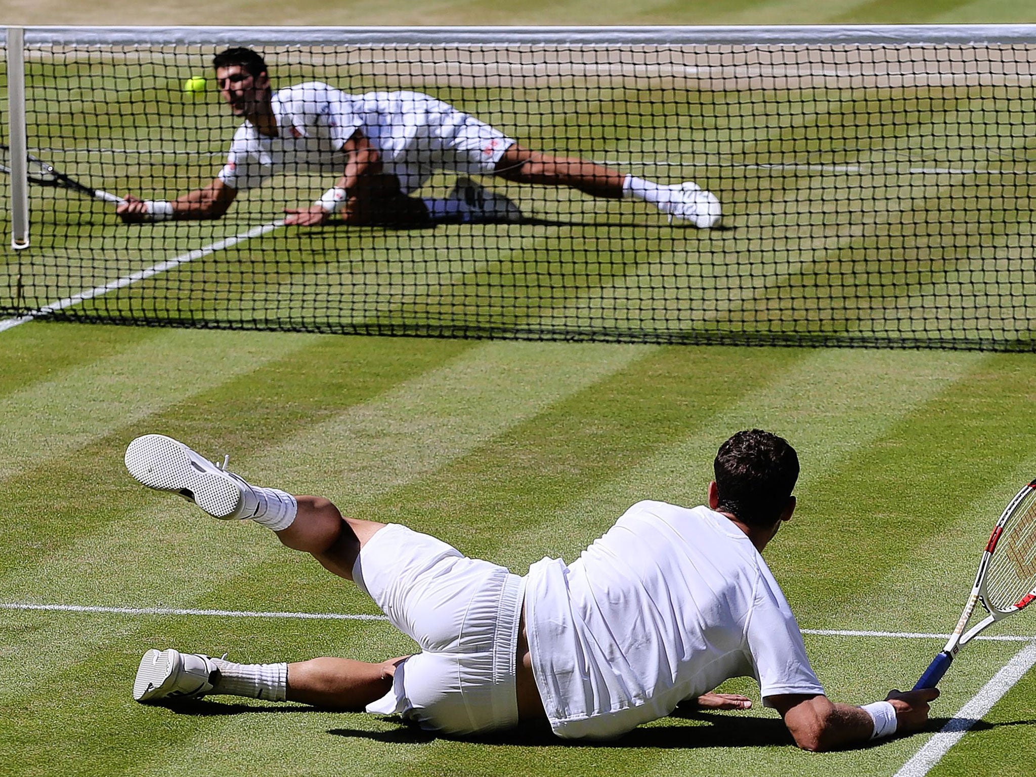 Novak Djokovic (top) and Grigor Dimitrov both slip on the worn surface of Centre Court