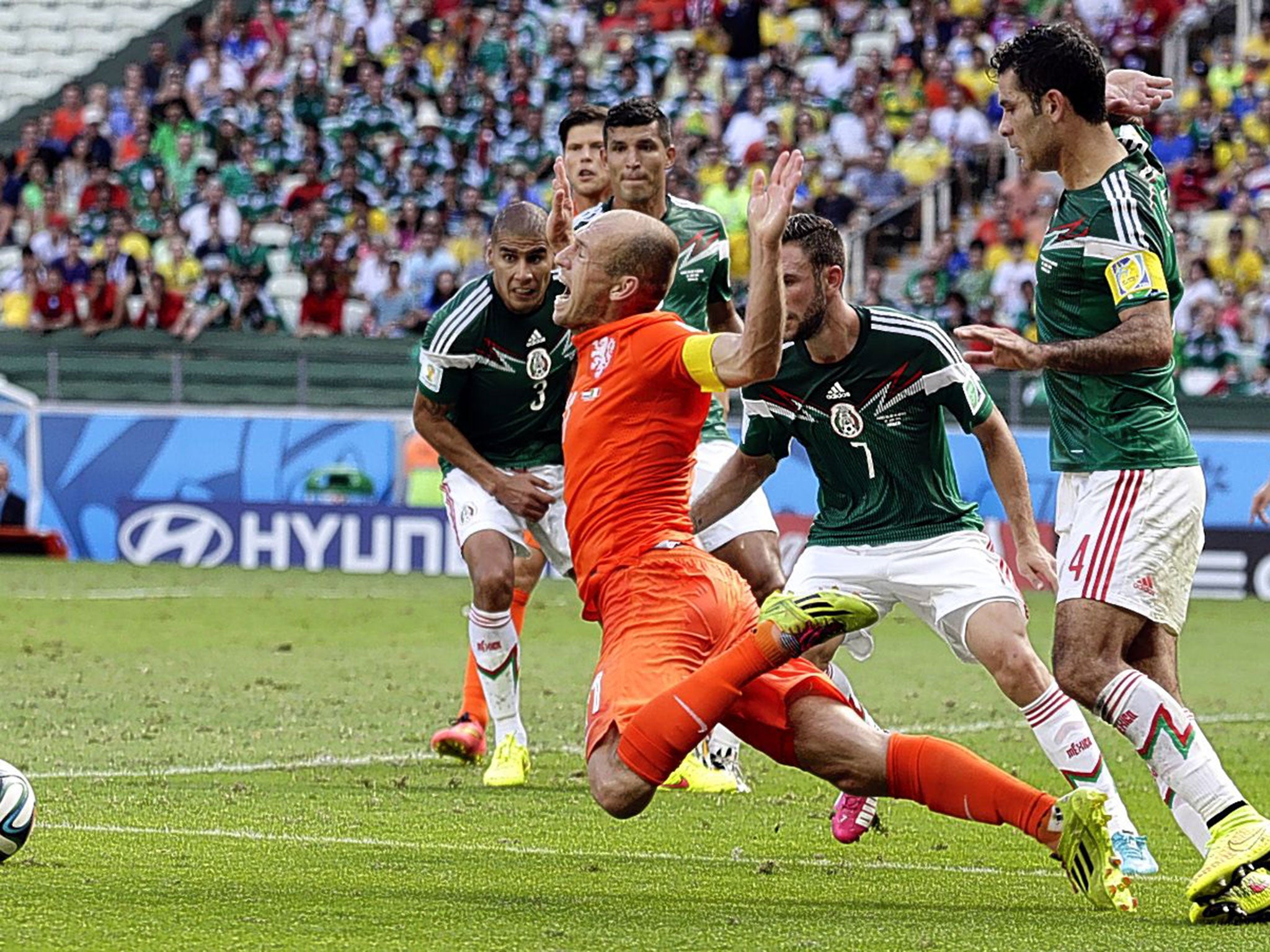 Arjen Robben goes down theatrically after being fouled by Mexico’s Rafael Marquez, leading to the penalty that put Netherlands into the World Cup quarter-finals