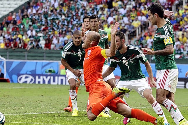 Arjen Robben goes down theatrically after being fouled by Mexico’s Rafael Marquez, leading to the penalty that put Netherlands into the World Cup quarter-finals