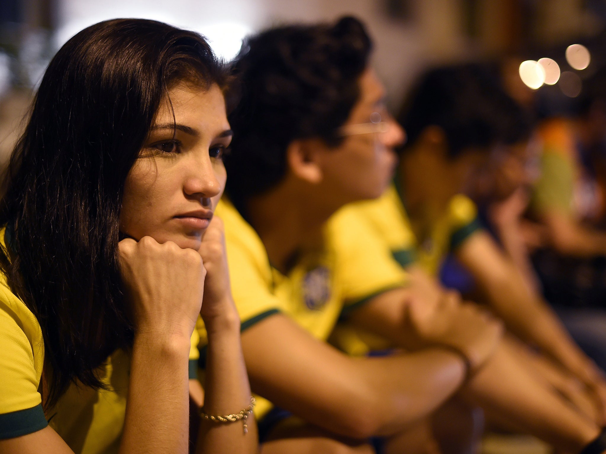Brazil football fans sit outside Sao Carlos Hospital where superstar striker Neymar was treated after being injured