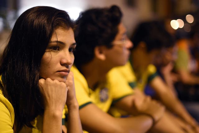Brazil football fans sit outside Sao Carlos Hospital where superstar striker Neymar was treated after being injured
