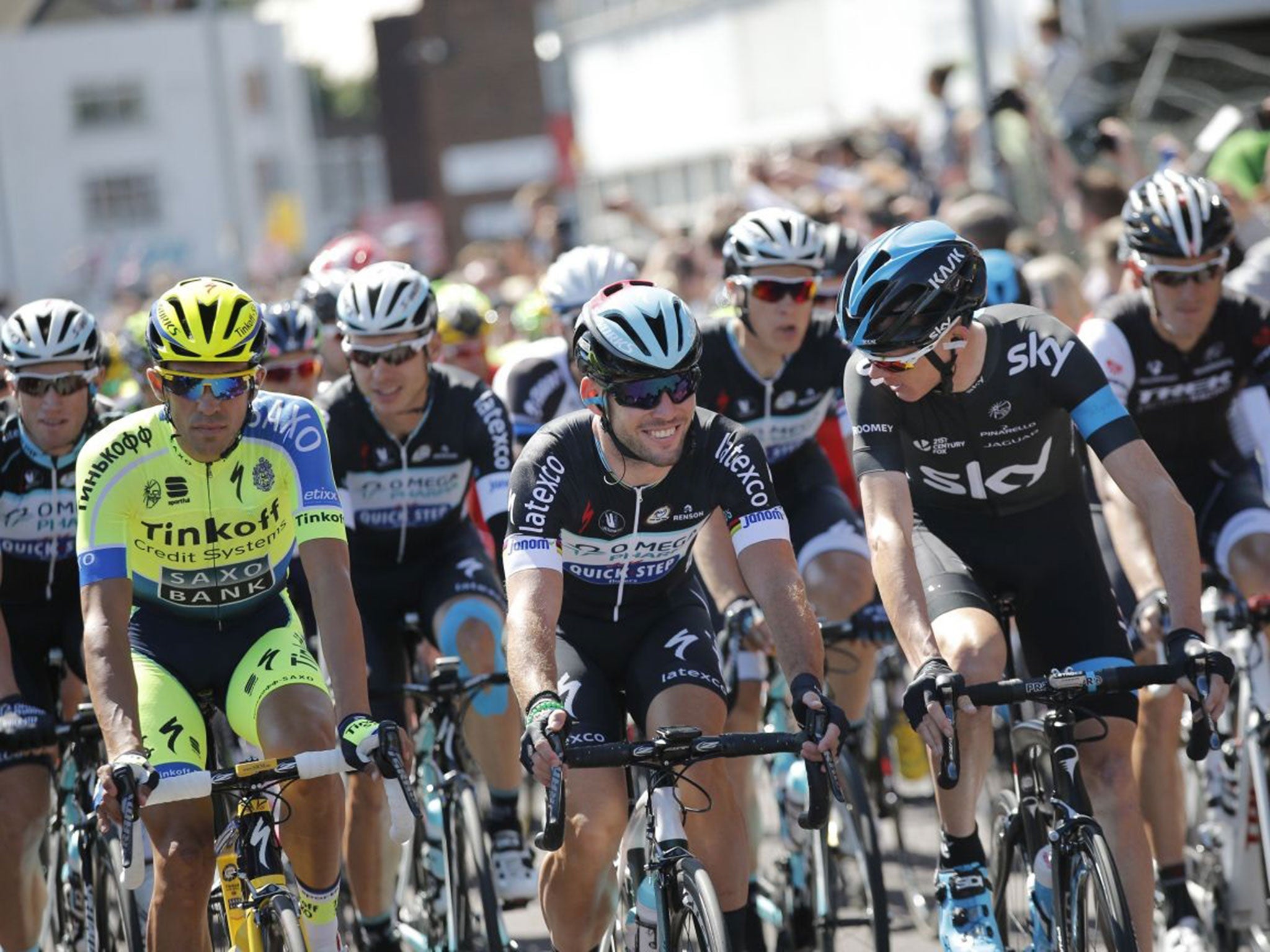 Spain's Alberto Contador, left, Mark Cavendish and Christopher Froome lead the pack during the ceremonial procession ahead of the start