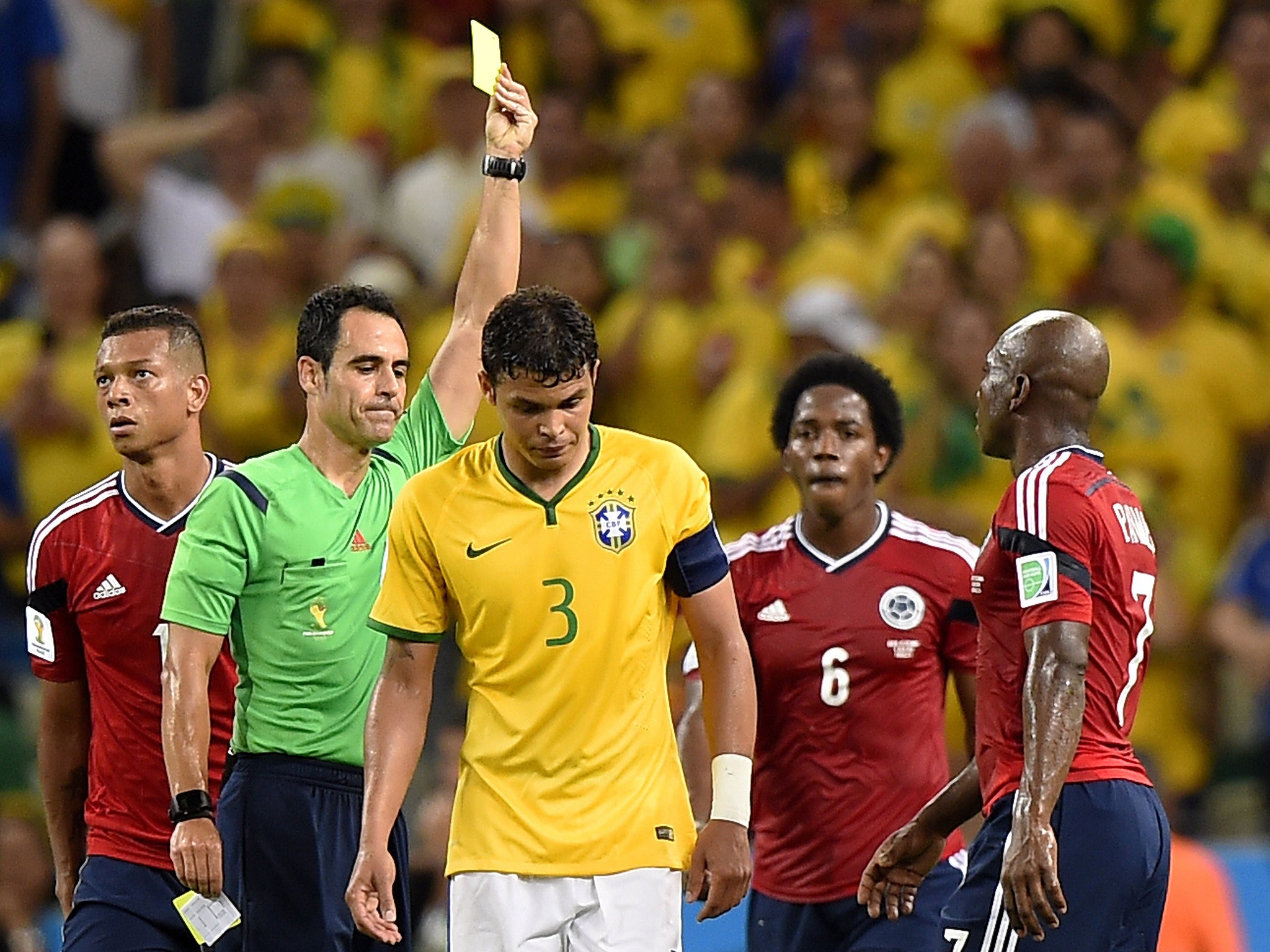 Carlos Velasco Carballo cautions Thiago Silva, a booking that rules the Brazil captain out of the semi-final with Germany