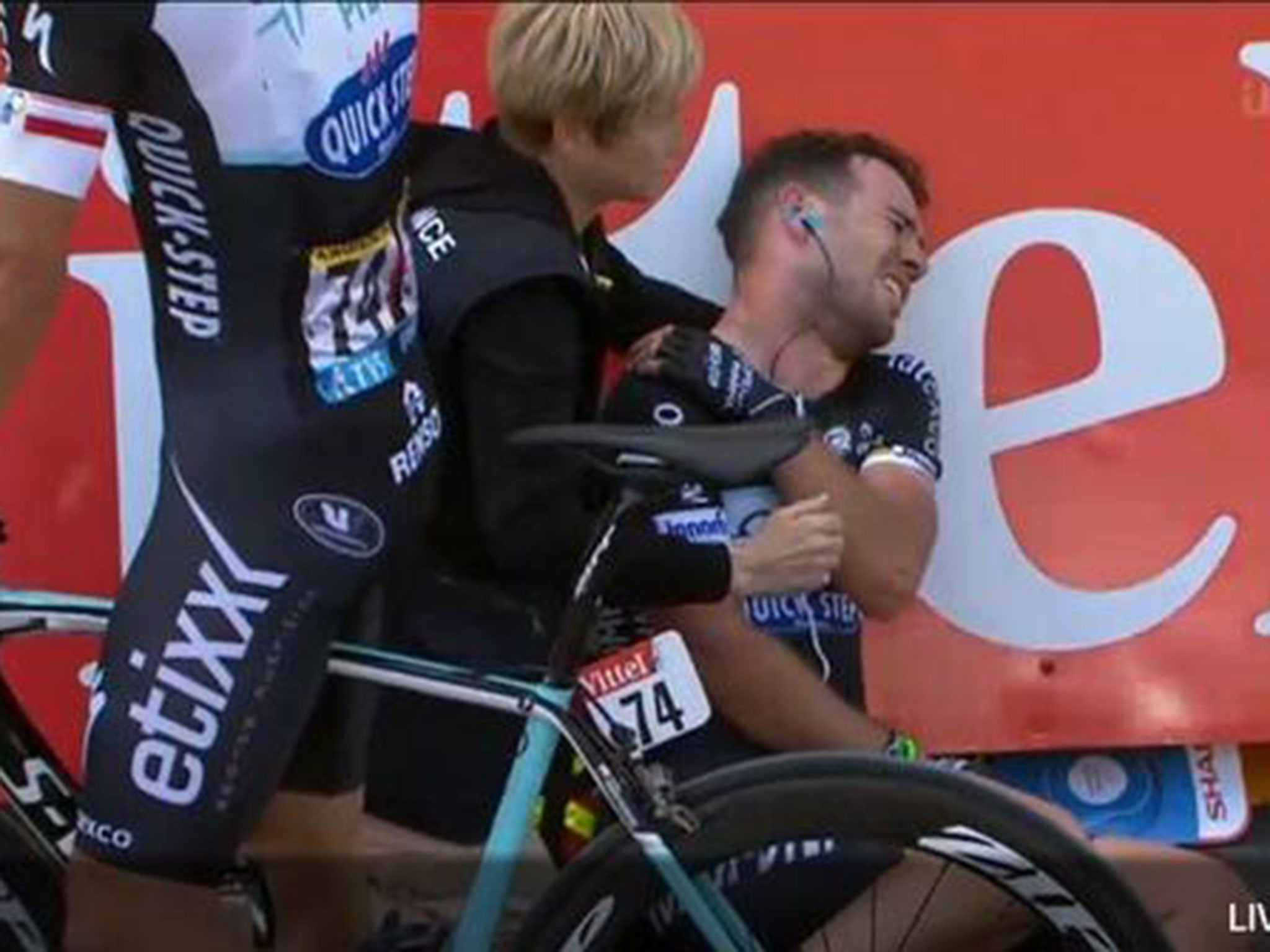 Mark Cavendish holds his collarbone in clear pain
