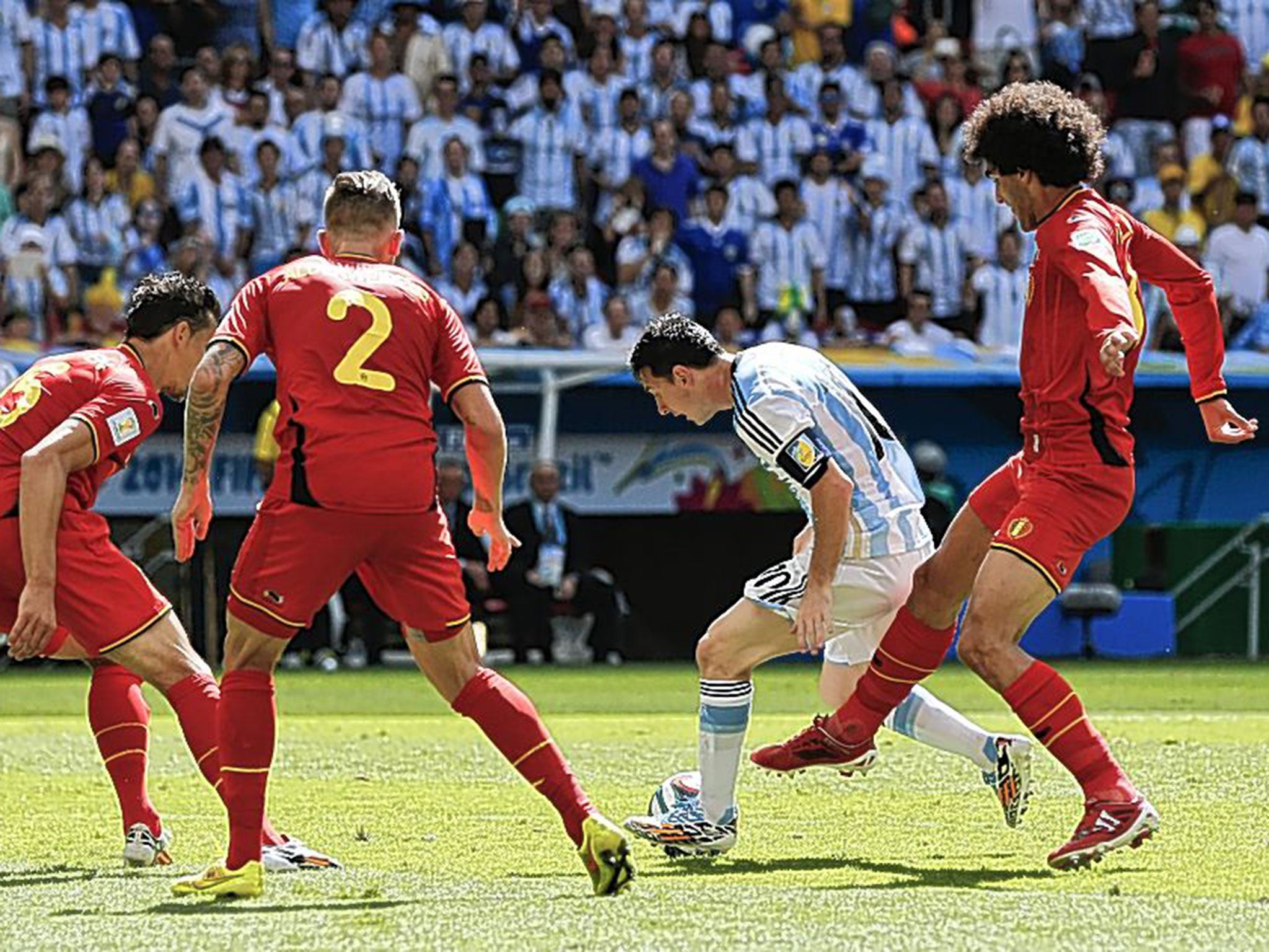 Little master: Lionel Messi (centre) tries to escape the attention of Marouane Fellaini and three other Belgian players