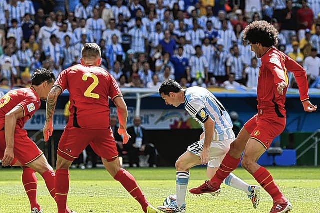 Little master: Lionel Messi (centre) tries to escape the attention of Marouane Fellaini and three other Belgian players 