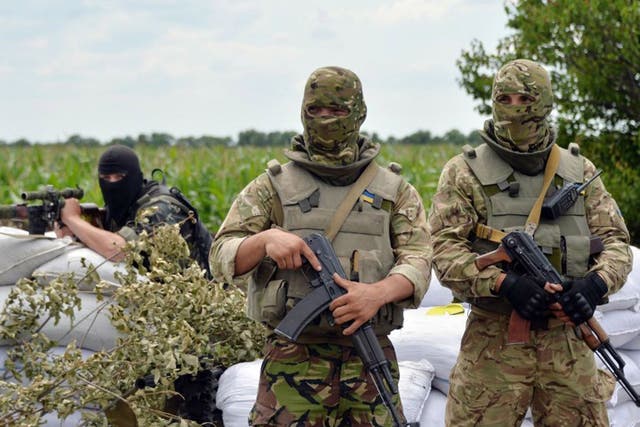 Ukrainian forces guard a checkpoint near Slovyansk on Friday 