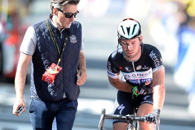 Yorkshire grit: A marshall looks concerned as an injured Mark Cavendish struggles on after his clash with Simon Gerrans and rides over the line 