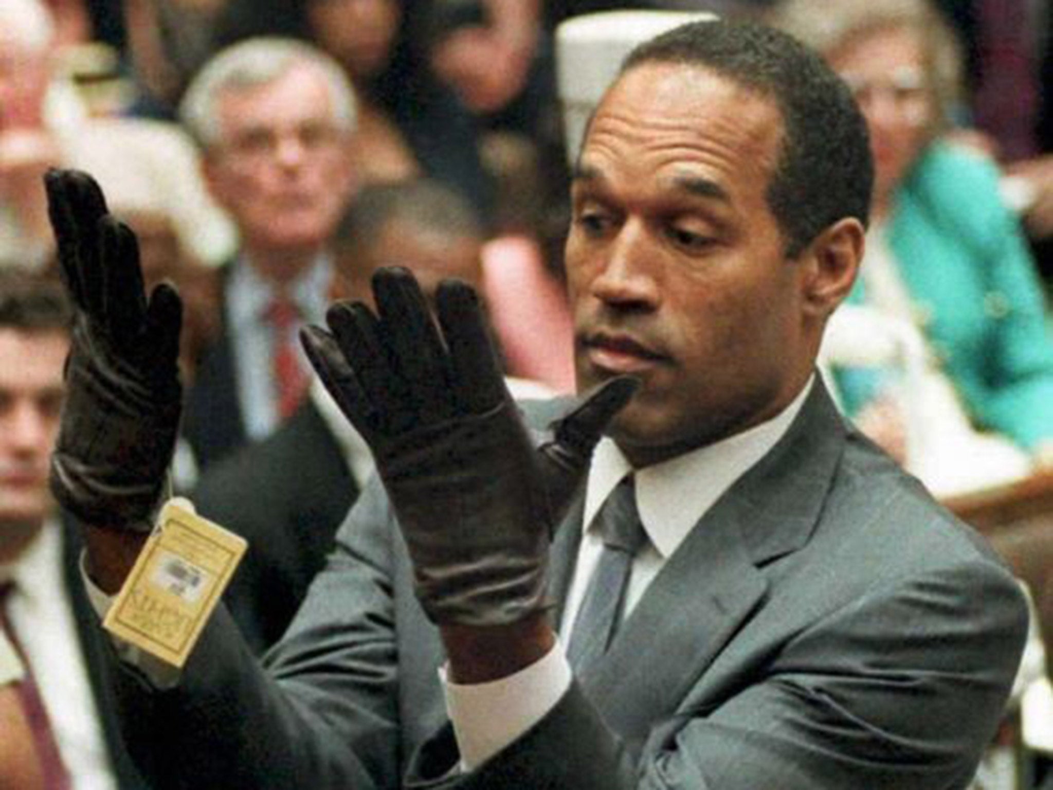 Fingered for the crime: O J Simpson tries on a glove presented as evidence in his trial