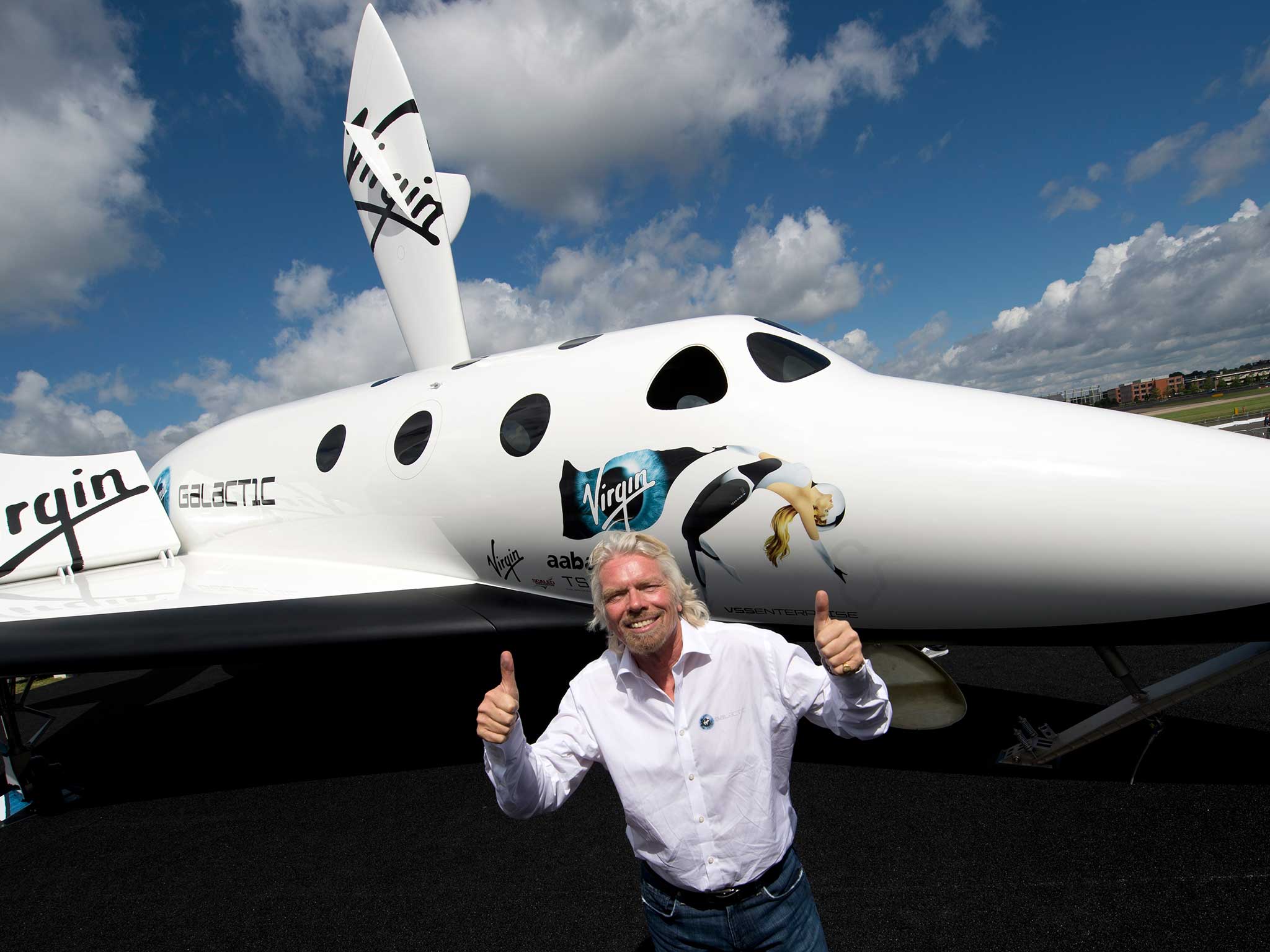 Richard Branson poses with a model for Virgin Galactic