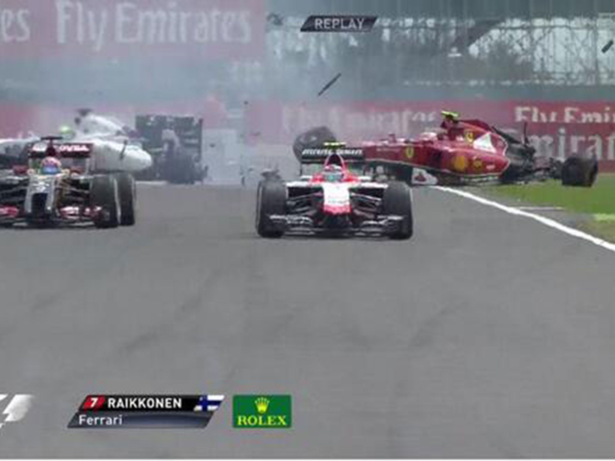 Kimi Raikkonen's heavily damaged Ferrari spins back on to the Silverstone track after hitting Felipe Massa