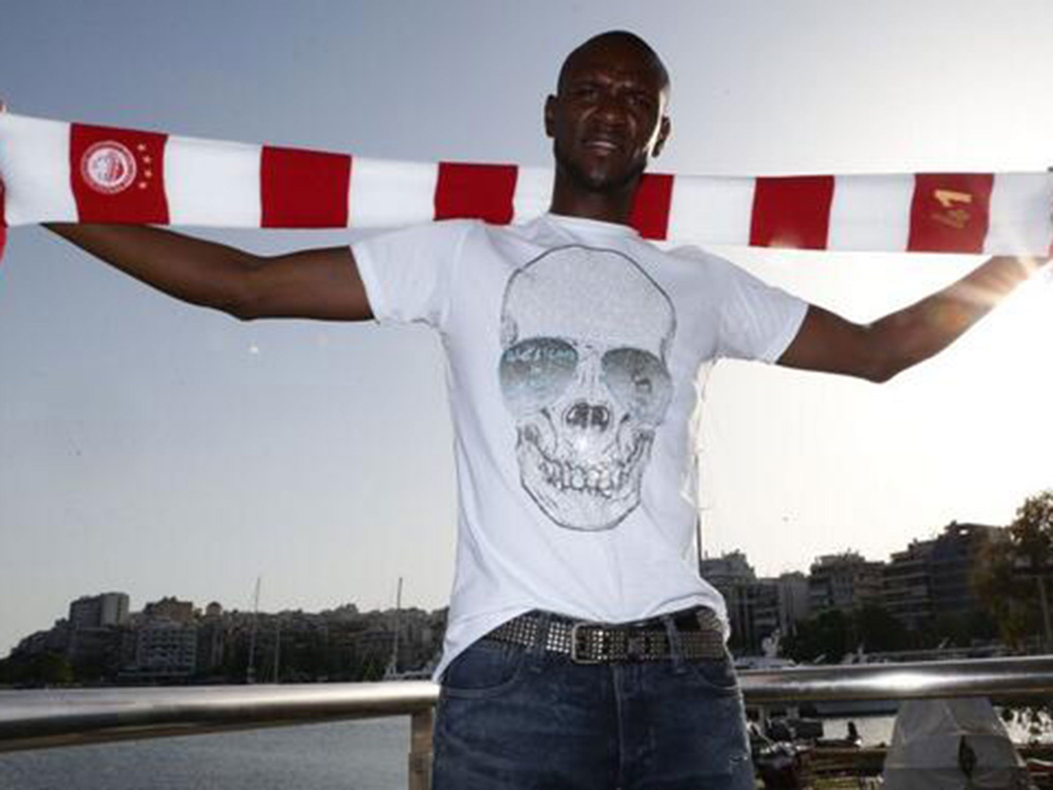 Eric Abidal is presented as an Olympiakos player
