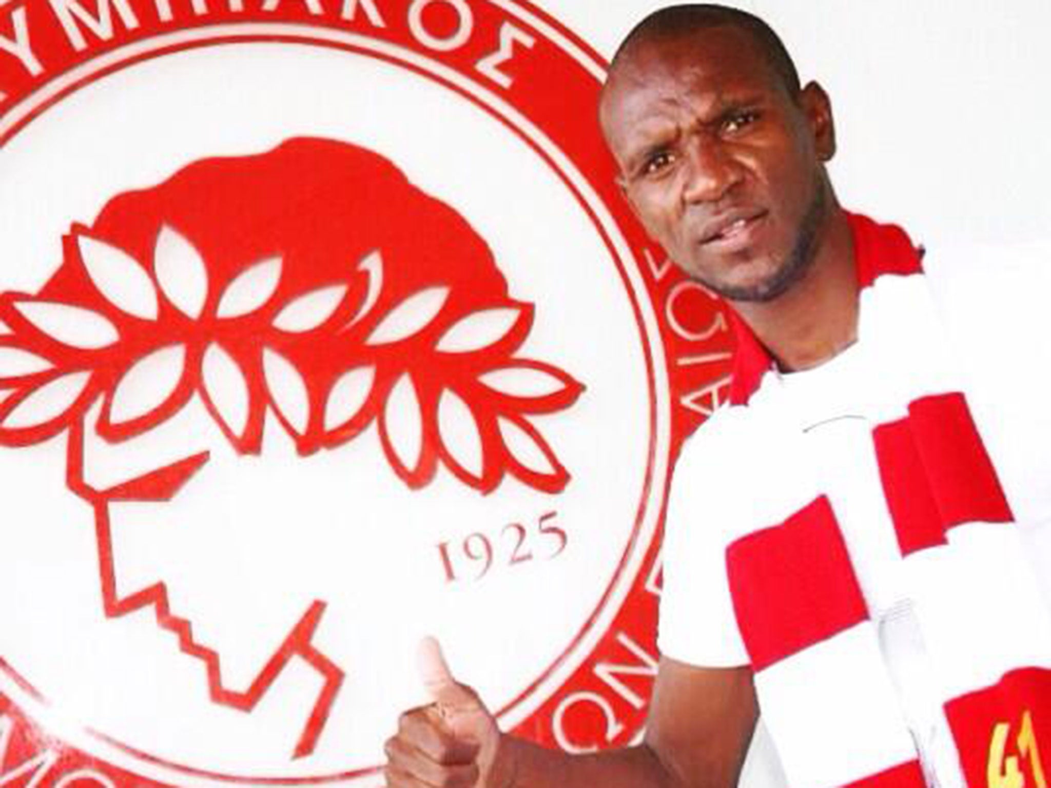 Eric Abidal is presented as an Olympiakos player