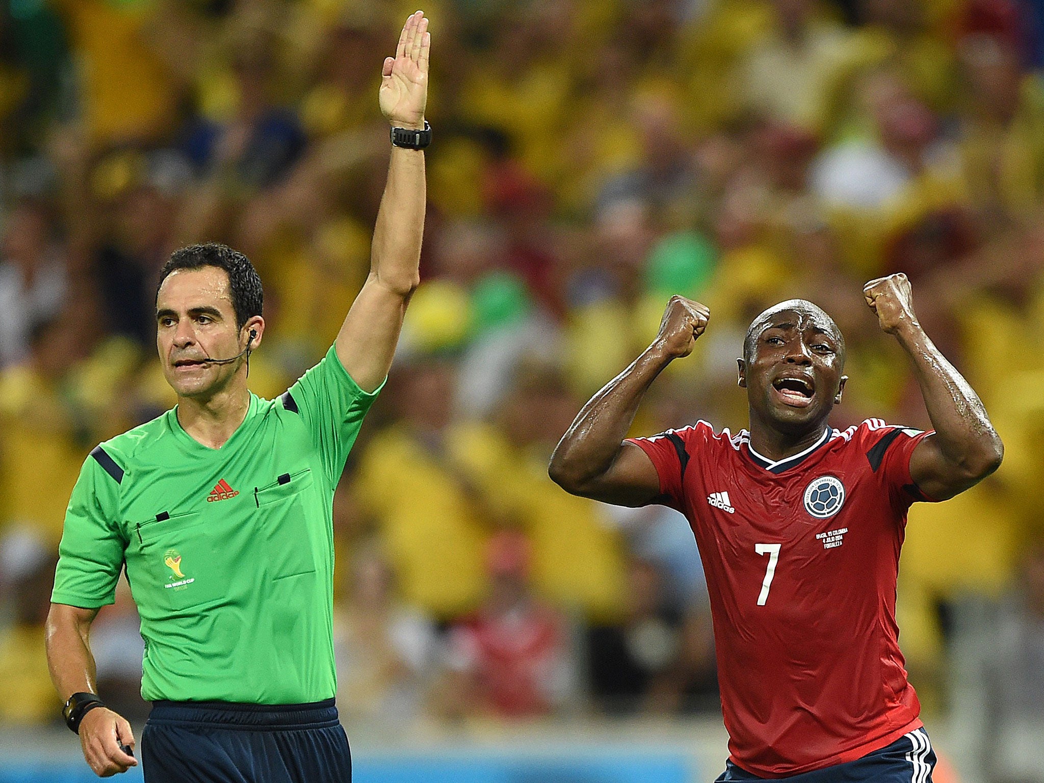 Colombia defender Pablo Armero shows his anguish as referee Carlos Velasco Carballo again resists the urge to book a Brazil player