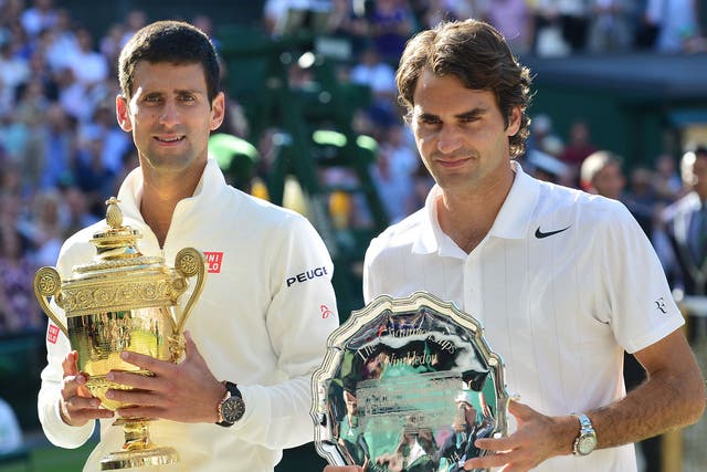 Novak Djokovic and Roger Federer pose with their trophies after the final