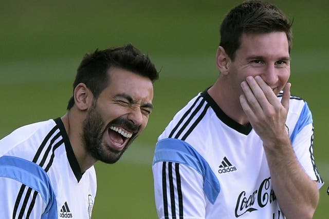 Ezequiel Lavezzi and Lionel Messi share a joke during training