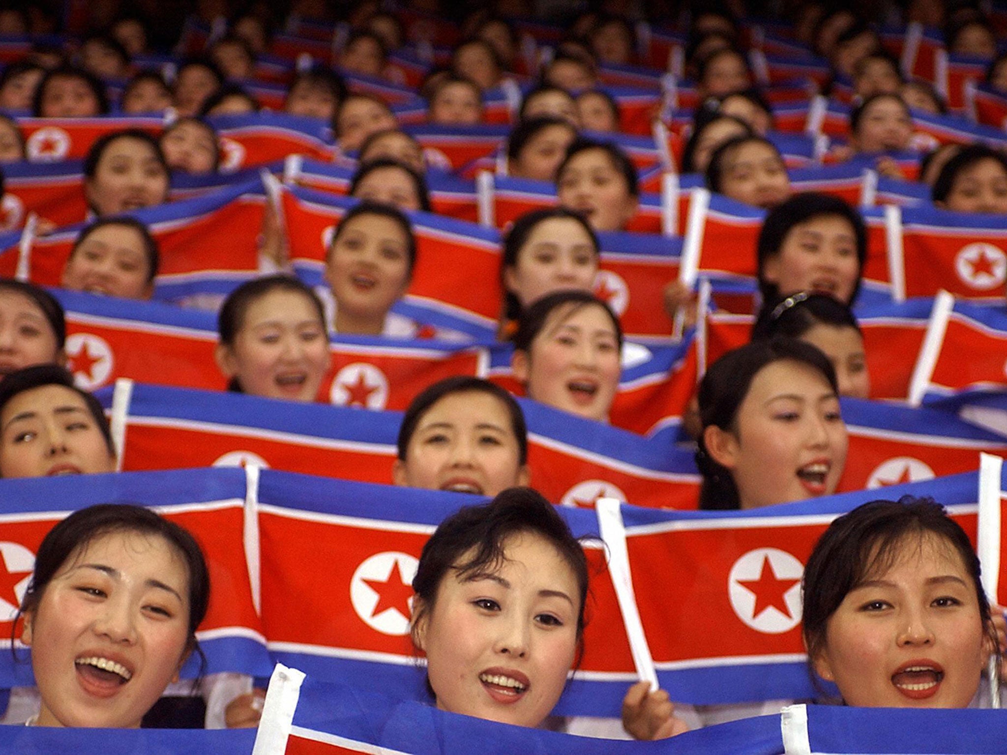 North Korean cheerleaders members wave their national flags during the 2003 World Students Games opening ceremony in Daegu