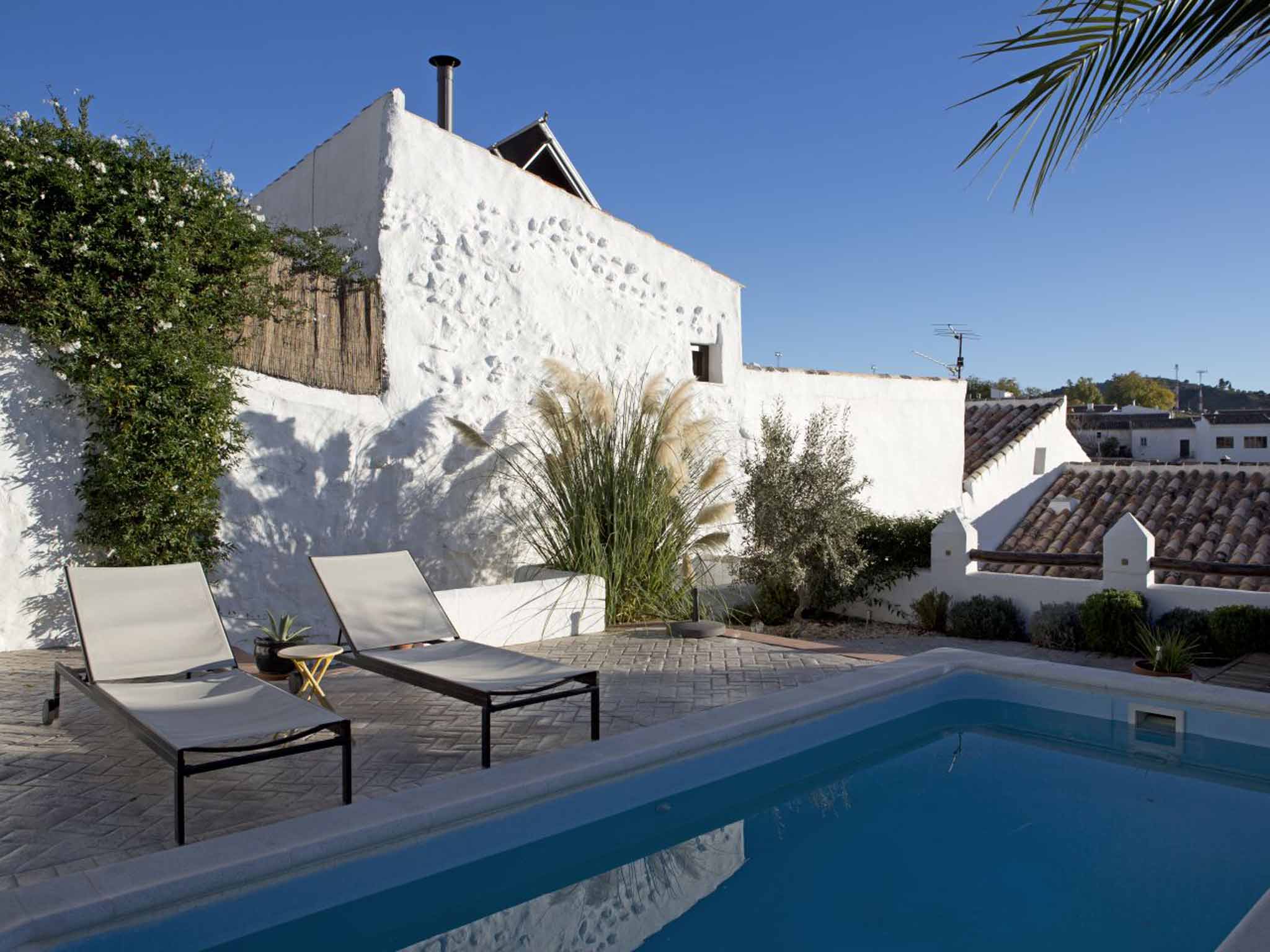 The pool and whitewashed exterior