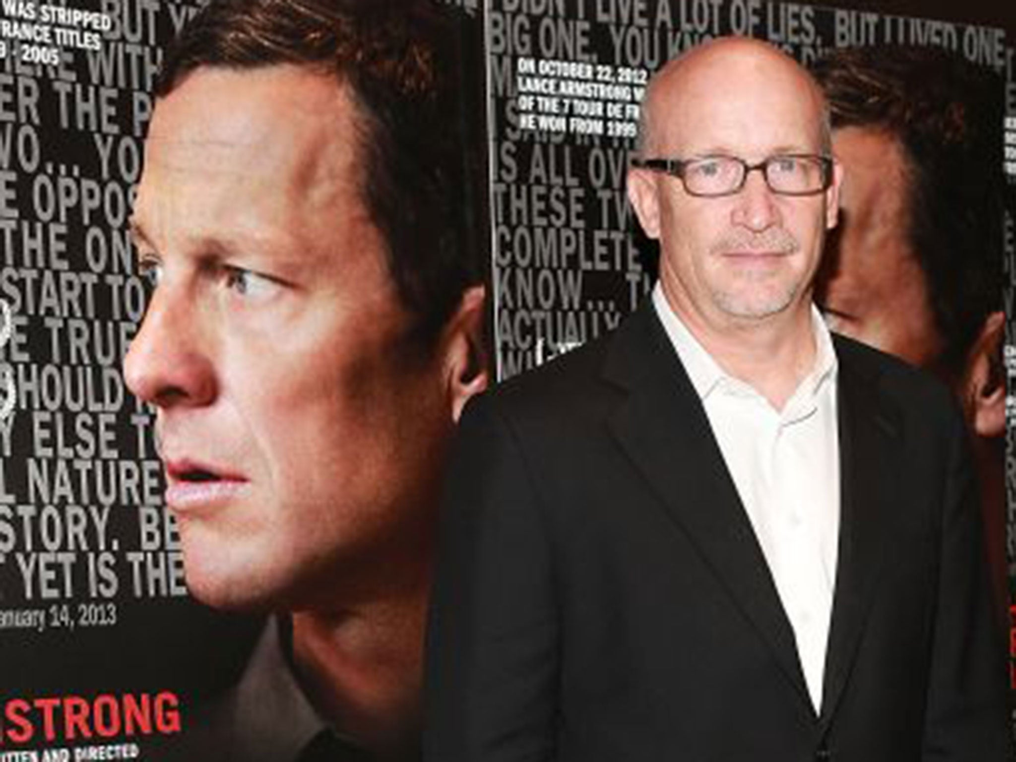 Alex Gibney with posters for ‘The Armstrong Lie’