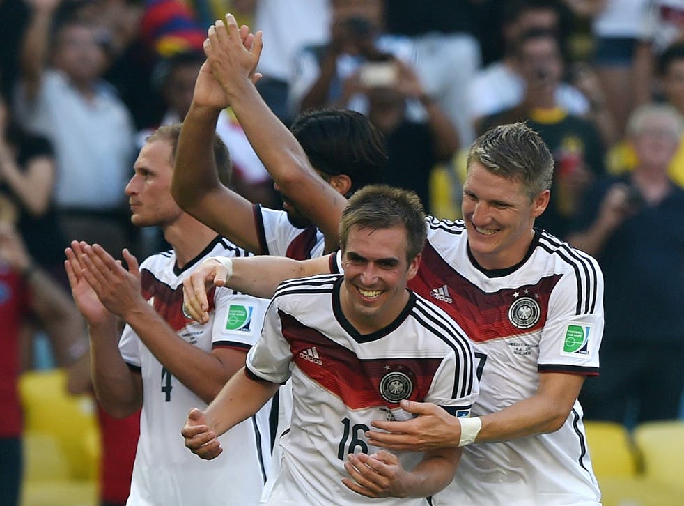 Germany's defender and captain Philipp Lahm (C) and midfielder Bastian Schweinsteiger (R) celebrate after winning the quarter-final against France