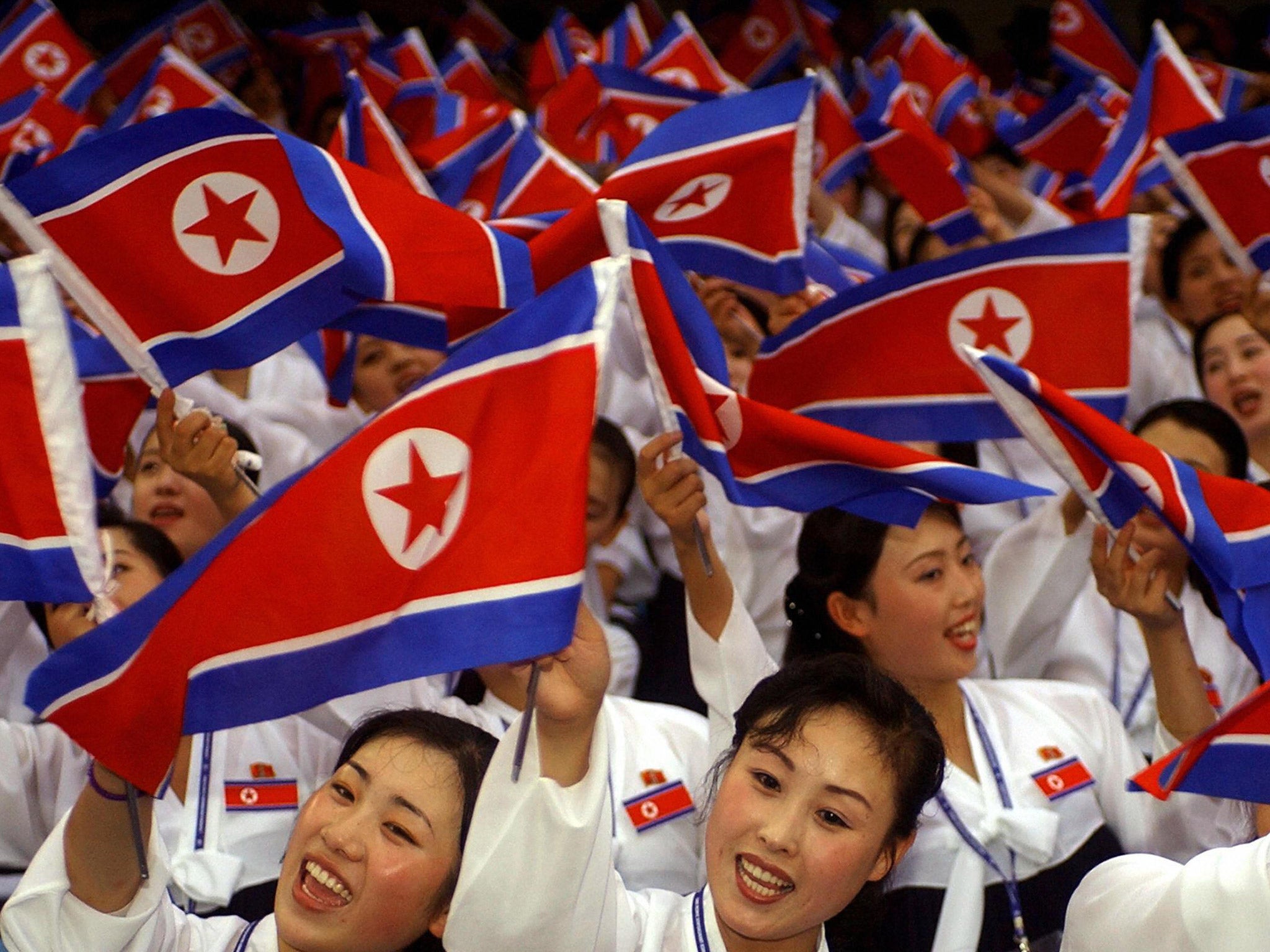 North Korean cheerleaders wave their national flags during the World Student Games in Daegu, South Korea, in 2003