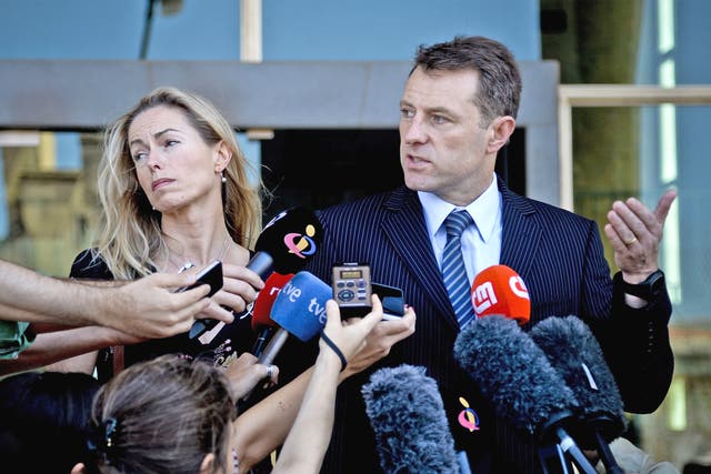 Kate McCann and her husband Gerry talk to reporters after they delivered statements to the court in Lisbon
