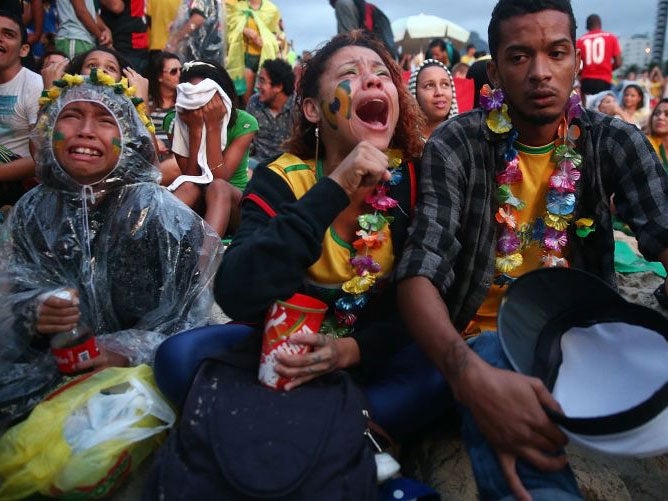 Brazil fans are devastated while watching the first half on Copacabana Beach during the 2014 FIFA World Cup semi-final match between Brazil and Germany on July 8, 2014 in Rio de Janeiro, Brazil. The winner advances to the final at the famed Maracana stadi