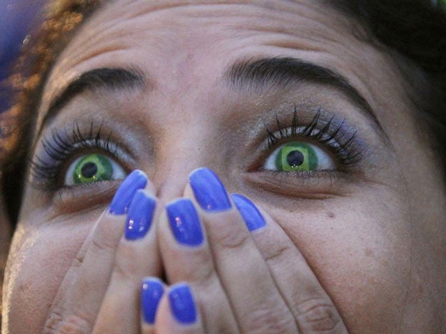 A Brazil fan watches her team lose to Germany in a World Cup semi-final