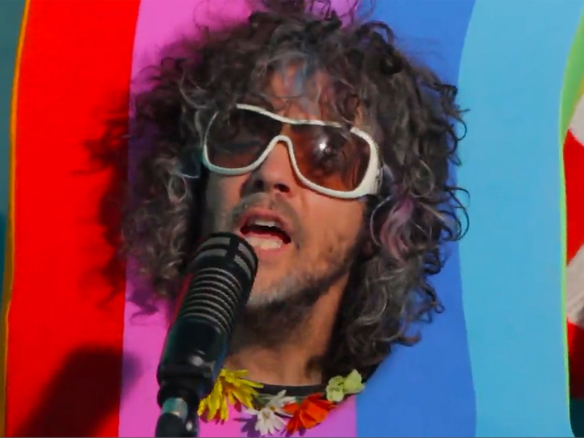 The Flaming Lips' Wayne Coyne sings from inside a rainbow