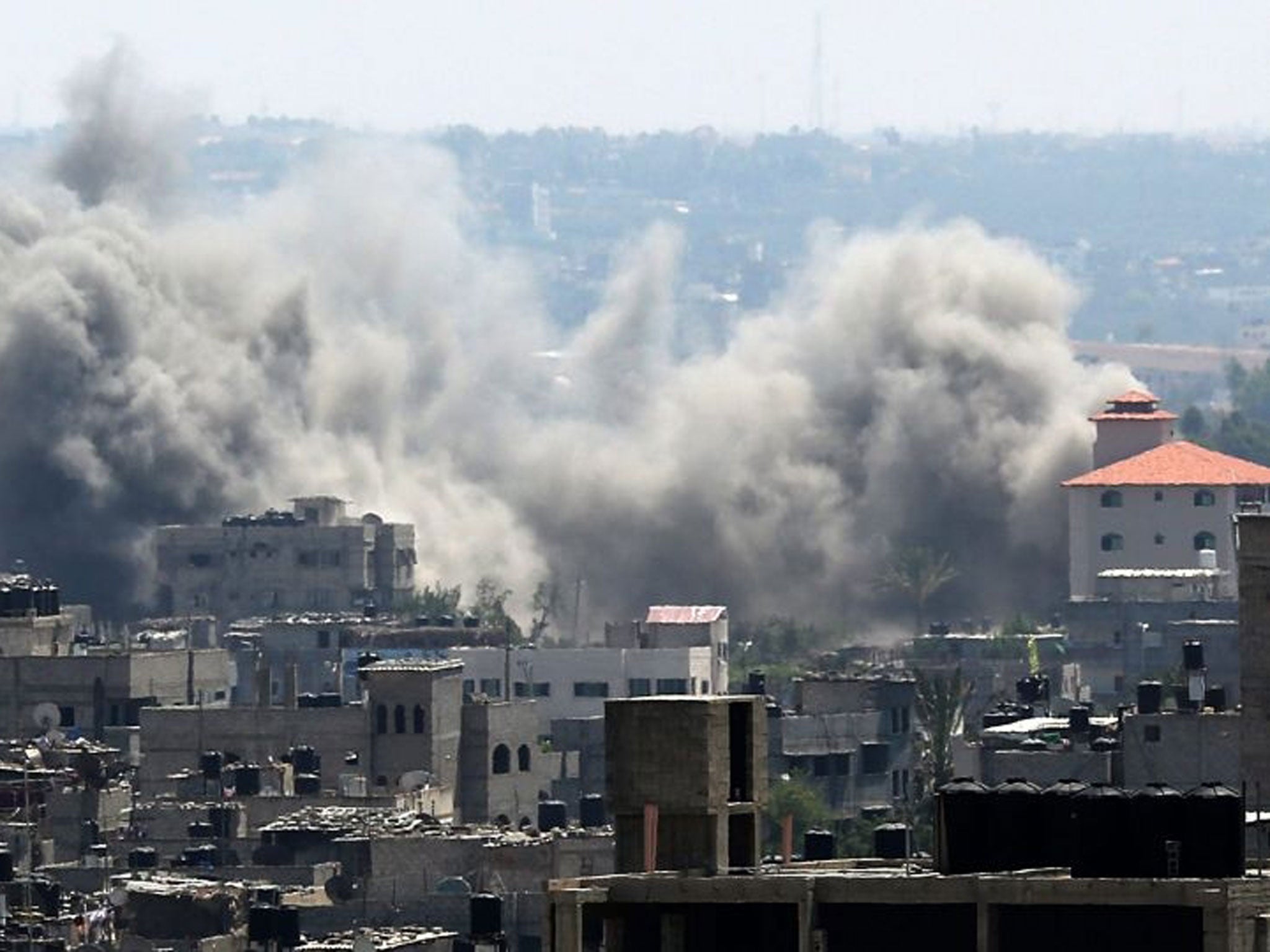 Smoke rises after an airstrike by Israeli forces in the south of Gaza City in July 2014 (EPA)