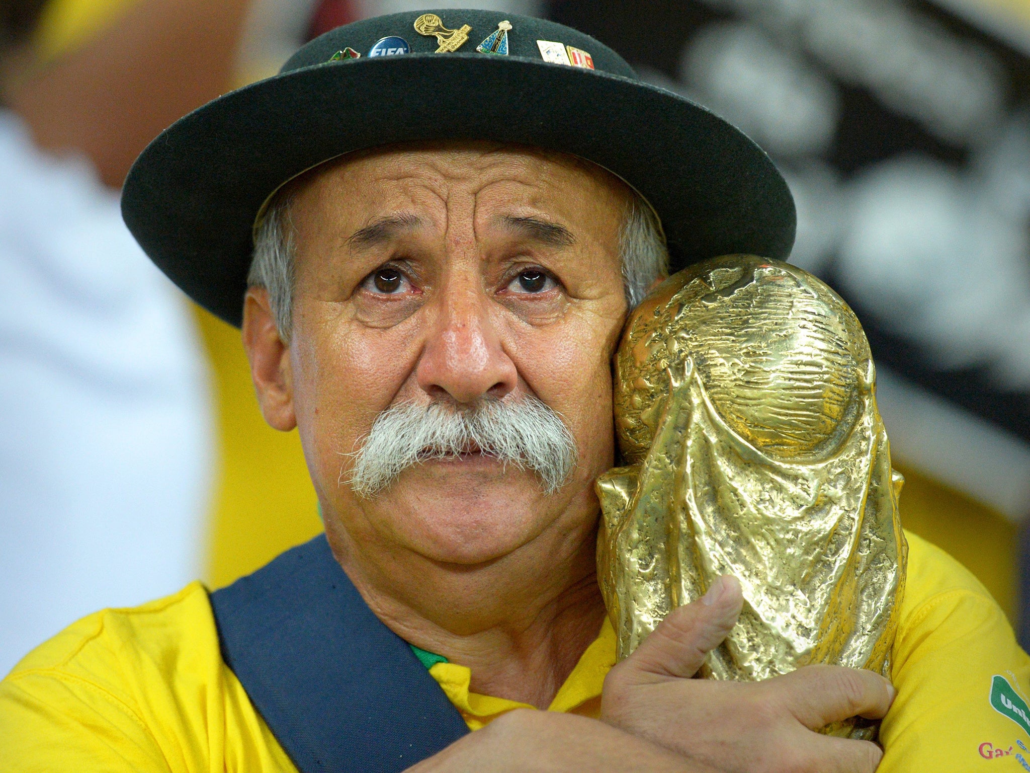 A Brazilian fan shows his dejection after the FIFA World Cup 2014 semi final match between Brazil and Germany at the Estadio Mineirao in Belo Horizonte, Brazil